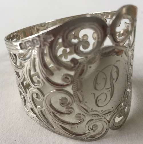 Solid silver decorative napkin rings and spoons