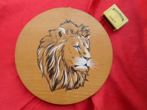 Picture of a lion on wood.  Display wall hanging.    Kruger National Park.  1962.