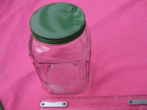 Large glass jar with green metal lid.