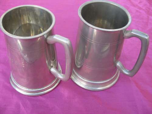 Pewter mugs,  one has dents.