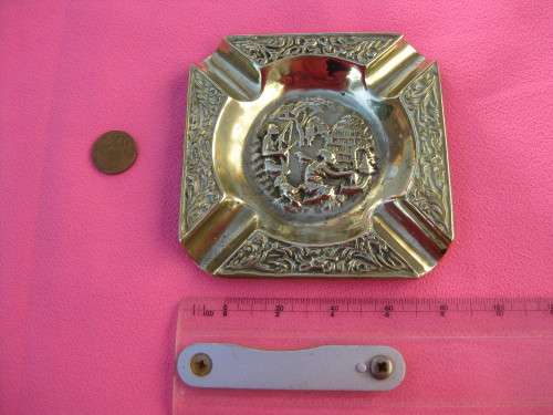 Brass ashtray with rural scene.