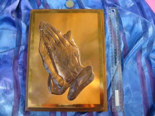 Picture of praying hands in pure copper.
