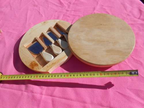 Cheese board with swivel wooden case enclosing knives.  Ready to place on the dining room table.