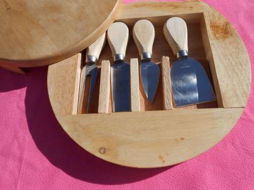 Cheese board with swivel wooden case enclosing knives.  Ready to place on the dining room table.