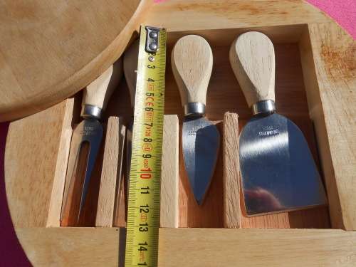 Cheese board with swivel wooden case enclosing knives.  Ready to place on the dining room table.