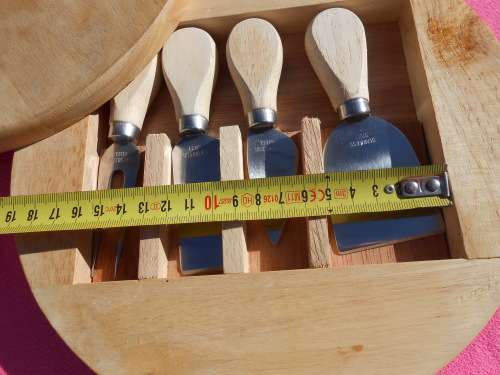 Cheese board with swivel wooden case enclosing knives.  Ready to place on the dining room table.
