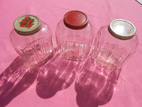 Ribbed glass jars with metal lids.