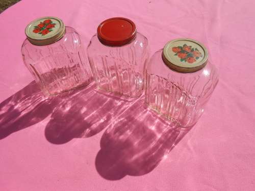 Ribbed glass jars with metal lids.