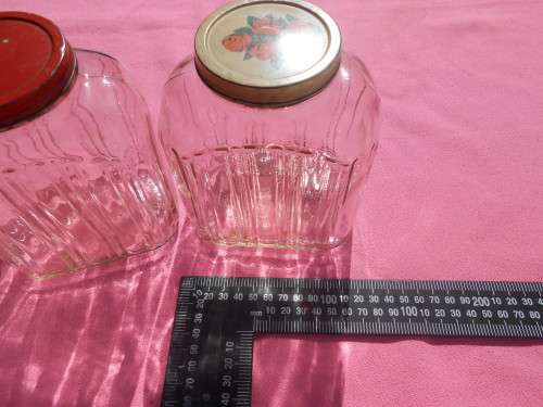 Ribbed glass jars with metal lids.