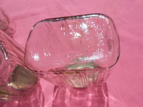 Ribbed glass jars with metal lids.