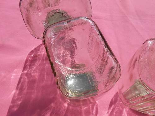 Ribbed glass jars with metal lids.