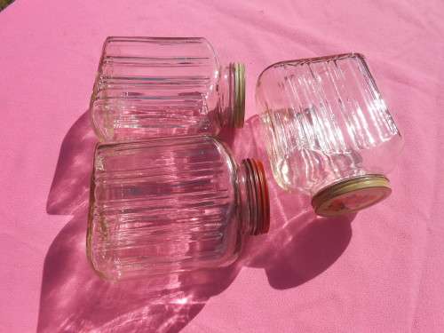 Ribbed glass jars with metal lids.