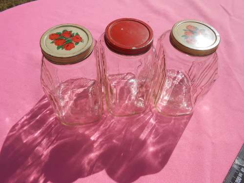 Ribbed glass jars with metal lids.