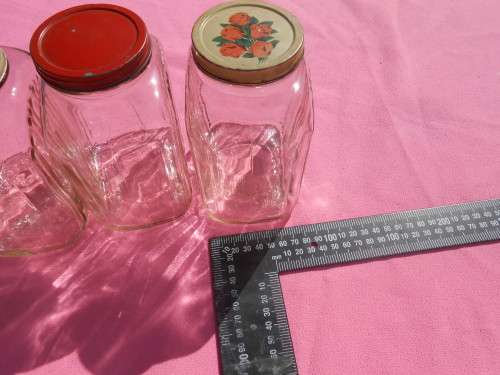 Ribbed glass jars with metal lids.