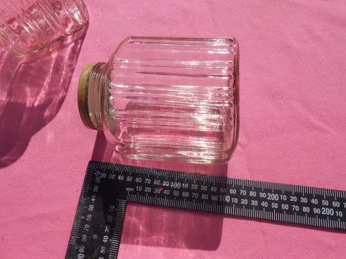 Ribbed glass jars with metal lids.