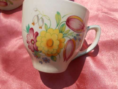 Susie Cooper.  Three saucers and six, SMALL, coffee cups.  No chips, cracks or repairs.