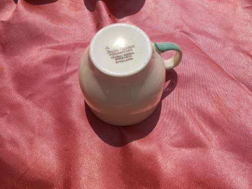 Susie Cooper.  Three saucers and six, SMALL, coffee cups.  No chips, cracks or repairs.