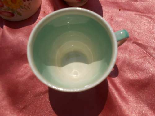 Susie Cooper.  Three saucers and six, SMALL, coffee cups.  No chips, cracks or repairs.