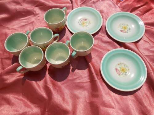 Susie Cooper.  Three saucers and six, SMALL, coffee cups.  No chips, cracks or repairs.