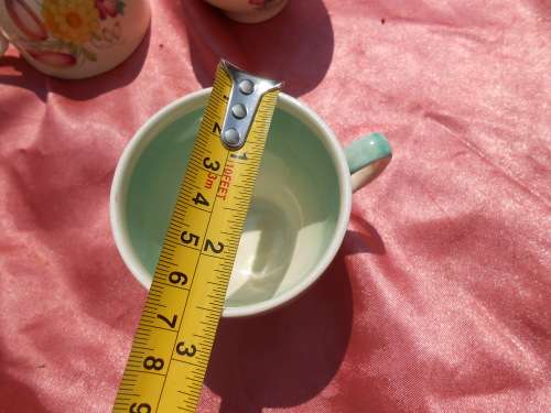 Susie Cooper.  Three saucers and six, SMALL, coffee cups.  No chips, cracks or repairs.