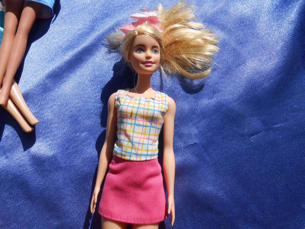 Four fashion dolls.  No markings.