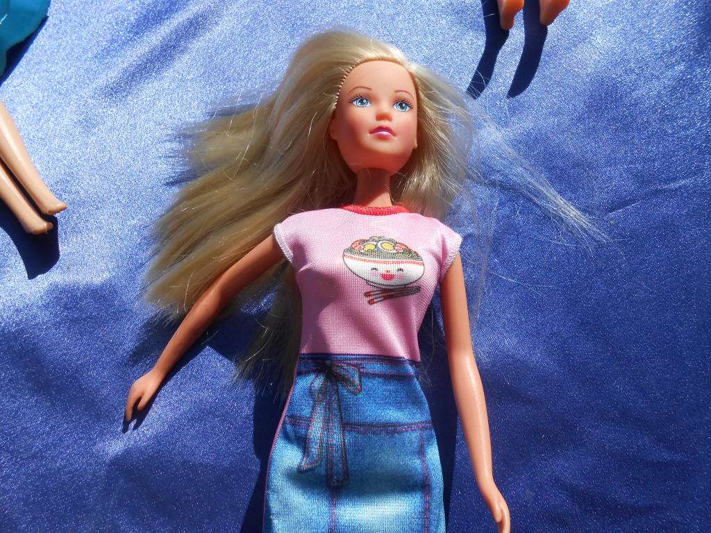 Four fashion dolls.  No markings.