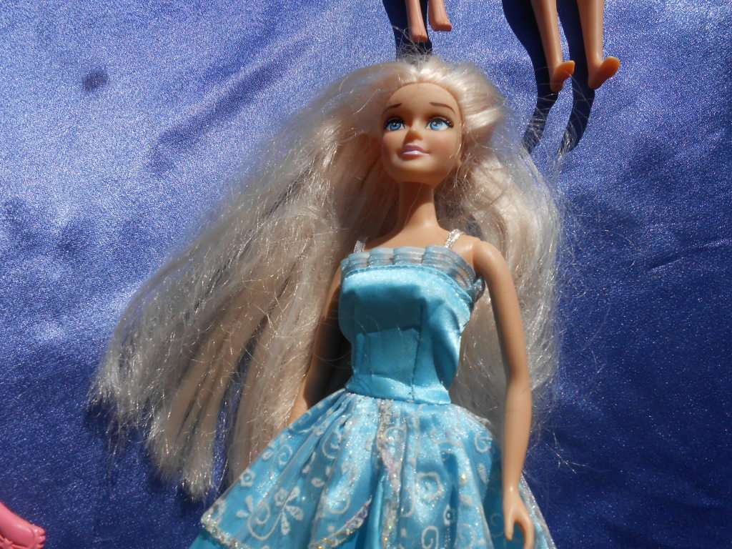 Four fashion dolls.  No markings.