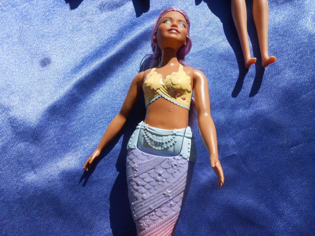 Four fashion dolls.  No markings.