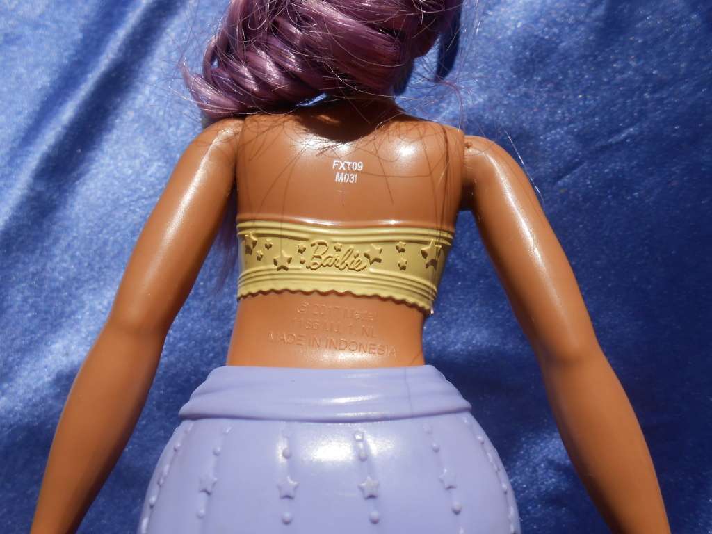 Four fashion dolls.  No markings.