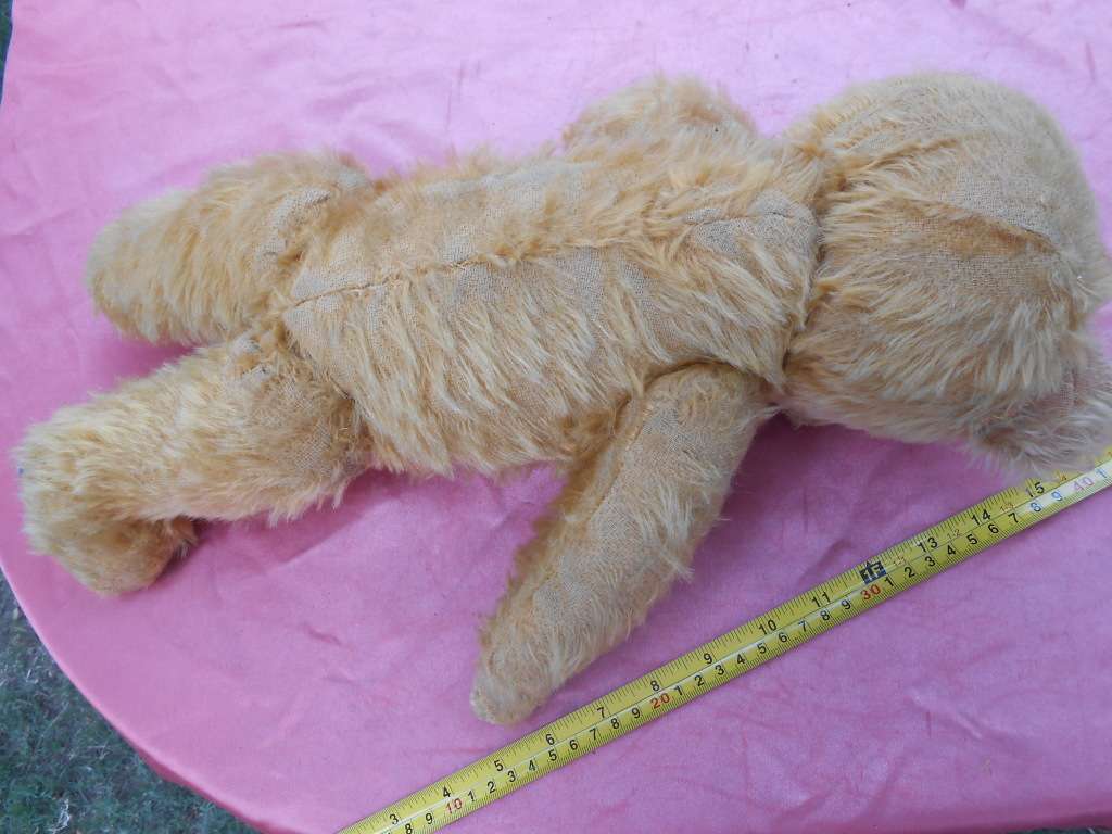Teddy bear. Much-loved condition - one ear has been sewn back on - as per photo.