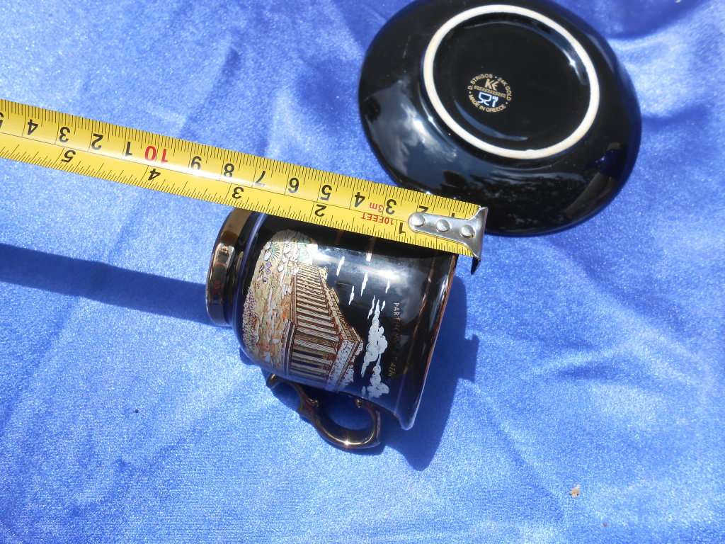 Small cup and saucer, stamped: D. Strigos.  24k gold trim.  Made in Greece.