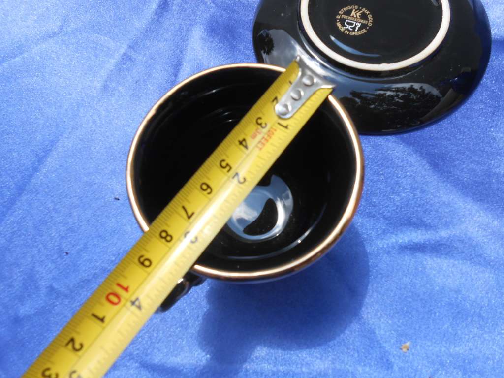 Small cup and saucer, stamped: D. Strigos.  24k gold trim.  Made in Greece.