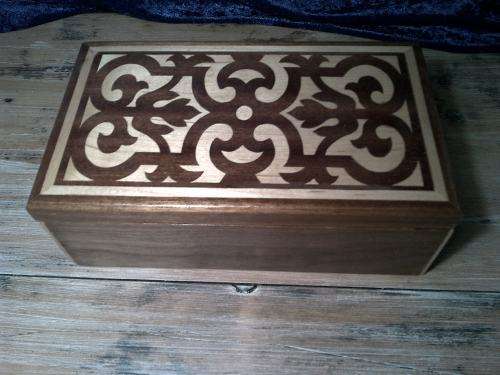 Wooden jewelery or trinket  box with dark and light  wood inlay.