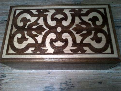 Wooden jewelery or trinket  box with dark and light  wood inlay.