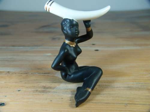 Vintage figurine of an African woman with Elephant Tusk on her head