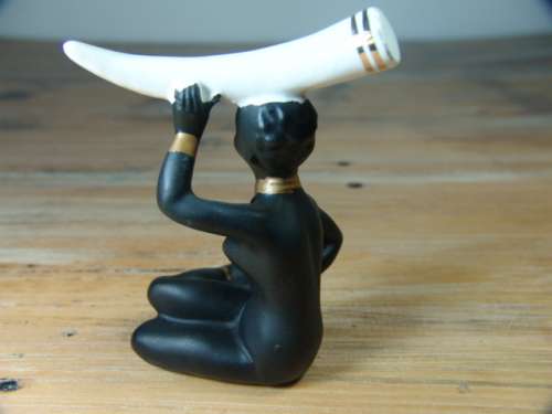 Vintage figurine of an African woman with Elephant Tusk on her head