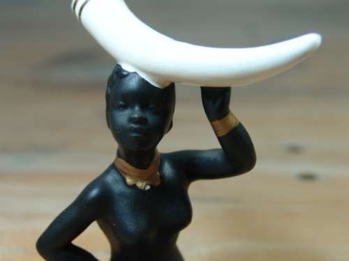 Vintage figurine of an African woman with Elephant Tusk on her head
