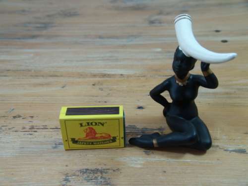 Vintage figurine of an African woman with Elephant Tusk on her head