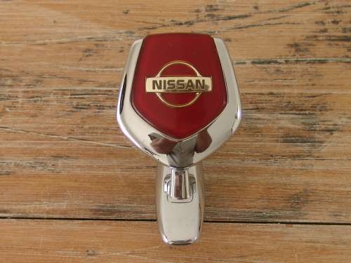 Vintage Nissan chrome car mascot, to open hood.