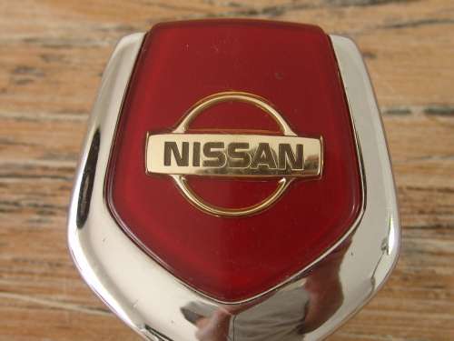 Vintage Nissan chrome car mascot, to open hood.
