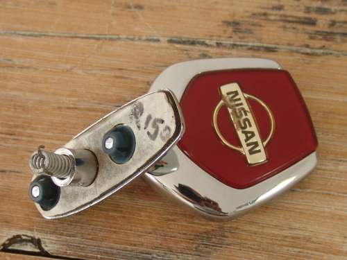 Vintage Nissan chrome car mascot, to open hood.