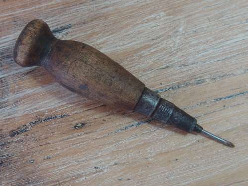 Vintage leather punching tool with wooden handle. Sharp point.