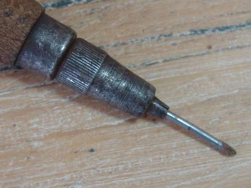Vintage leather punching tool with wooden handle. Sharp point.