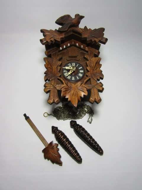 German mechanical Black Forest Cuckoo Clock with pendulum and weights and in excellent working cond.