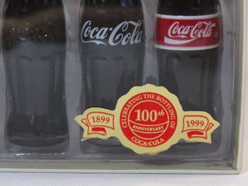 1999 Boxed set of 6 Coca Cola miniature glass Bottles.Evolution of the contour bottle 1899-1999 mint