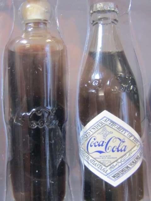 1999 Boxed set of 6 Coca Cola miniature glass Bottles.Evolution of the contour bottle 1899-1999 mint