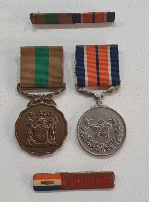 Two SADF medals with name tag as per photo.