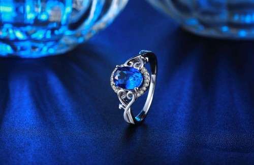 White Gold Filled Ring With 16 Simulated Diamonds And Blue Sapphire