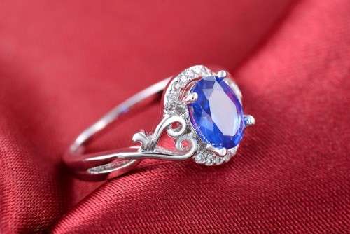 White Gold Filled Ring With 16 Simulated Diamonds And Blue Sapphire