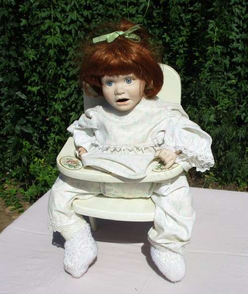 PORCELAIN DOLL ON CHAIR
